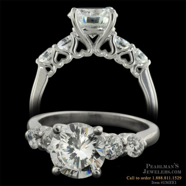 This ring features 60ct in side diamonds and heart shaped filigree visible 