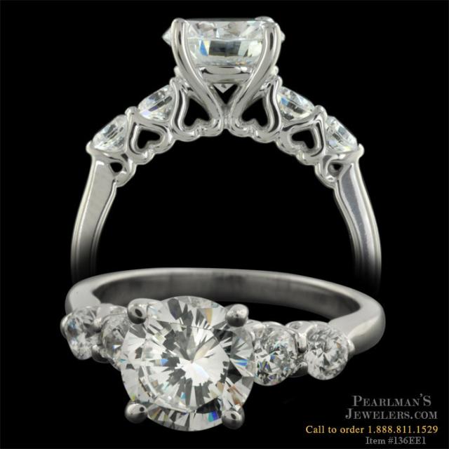 This ring features 60ct in side diamonds and heart shaped filigree visible