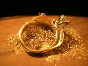 laying in pile of yellow gold and rose gold shavings from ring making process.JPG