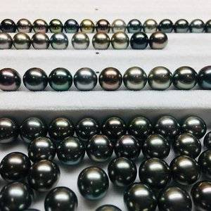 Same round strand loose pearls under lights and direct light.jpg