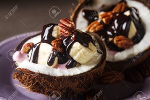 89547075-fruit-salad-with-coconut-banana-yogurka-drizzled-with-hot-dark-chocolate-dark-backgro...jpg
