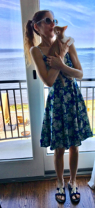 missywearingsundresswithsandalskissingoliver.png