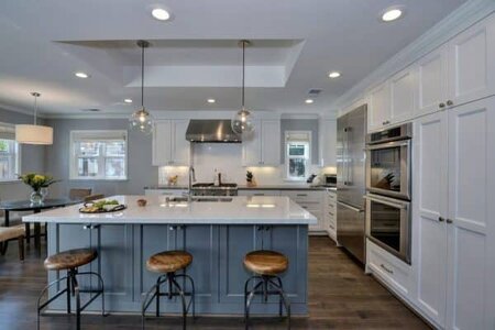 luxury-kitchen-with-white-shaker-cabinets-blue-island-with-white-marble-counters-and-globe-pen...jpg