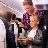 777-200-economy-child-flight-attendant-handing-lollies-exp-301122-800x800__FocusFillWzE1NiwxNT...jpg