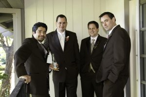 8men standing around in their brown suits.JPG