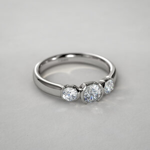 1622397041940_10671_half_bezel_set_three_stone_diamond_ring_angle.jpg