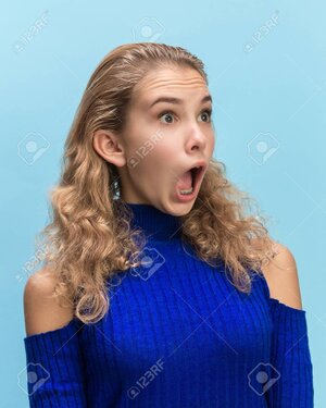 112330190-the-surprised-and-astonished-young-woman-screaming-with-open-mouth-isolated-on-blue-...jpg