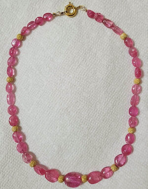 Pink tourmaline and gold beaded necklace.jpg