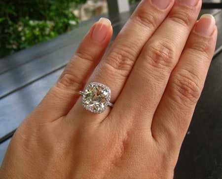 4 carat cushion cut diamond ring on hand