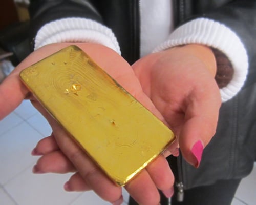 Fairmined gold bar held by AURELSA president Rosa Reyes