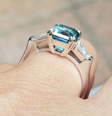 mochiko42’s 3 Stone Emerald Cut Blue Zircon Ring (Side Angle View) - image from mochiko42