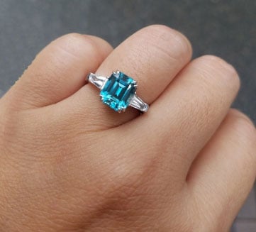 mochiko42’s 3 Stone Emerald Cut Blue Zircon Ring (Hand View) - image from mochiko42