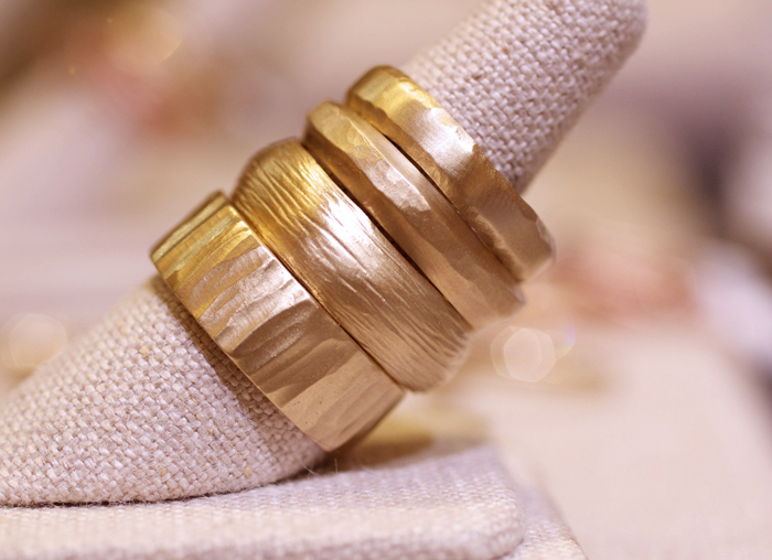 Textural gold wedding bands designed by Rebecca Overmann • Image Erika Winters