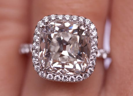 Cushion cut diamond ring with pave halo setting