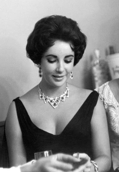 Elizabeth Taylor wearing Diamond and ruby Cartier suite