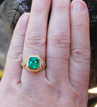 Emerald ring on the hand