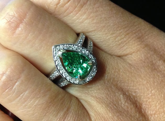 Halo diamond ring with green garnet