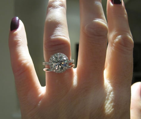 Hearts and Arrows diamond halo ring on the hand