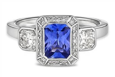 Three-stone diamond and emerald cut sapphire halo ring set in platinum at Ritani