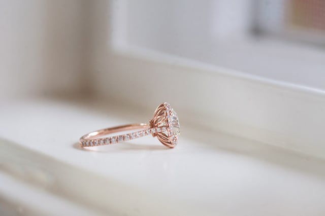 Custom diamond halo engagement ring in rose gold