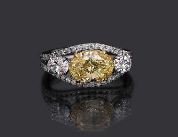 Custom oval-cut yellow diamond three-stone ring by Leon Megé