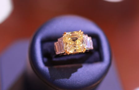 Fancy intense yellow royal asscher cut diamond ring weighing 4.38 carats