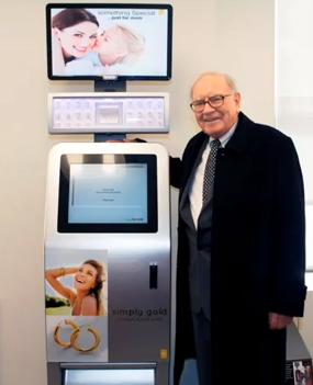 Warren Buffett stands next to the Precious Express Kiosk