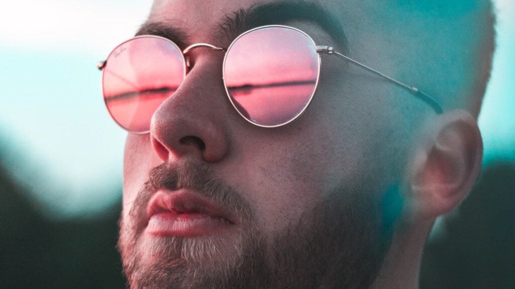 Reflections in glasses on man with beard