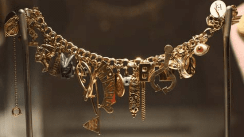 Gold and multi-gem charm bracelet.