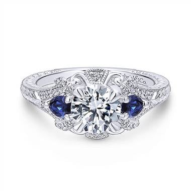 Vintage 14K white gold diamond and sapphire three stone halo engagement ring at Gabriel & Co.