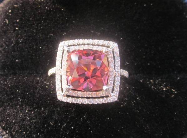 ZestfullyBling originally posted her incredible double halo pink tourmaline engagement ring on the Show Me the Bling forum at PriceScope. This is a 20th anniversary Engagement Ring upgrade featuring ZestfullyBling’s birthstone! How fabulous!