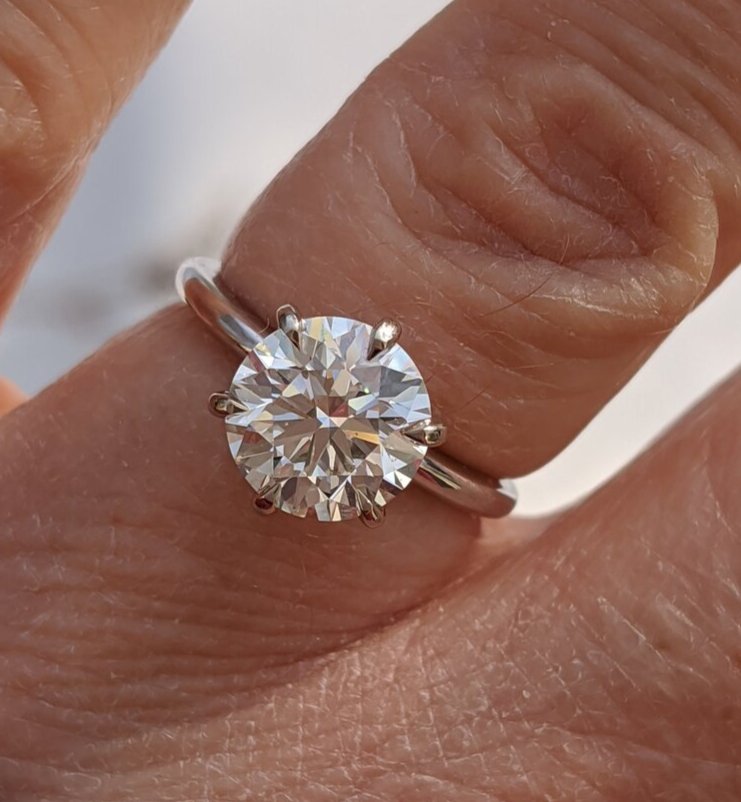 Soxfan posted this beautiful Crafted by Infinity Solitaire  the Show Me the Bling forum at PriceScope.  This ring is stunning, can you believe that diamond is a K!? It’s such an impressive beauty!