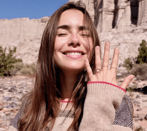 Close up image of American actress Lily Collins and her Rose cut engagement ring.