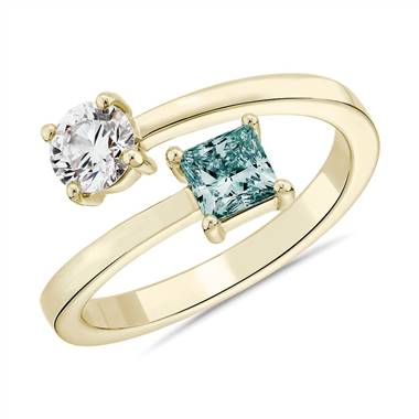 A lightbox lab grown blue diamond round and princess bypass ring set in 14K yellow gold at Blue Nile.
