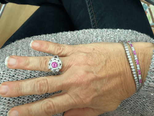 Front view of a pink sapphire and diamond ring, bracelet and bangle. 