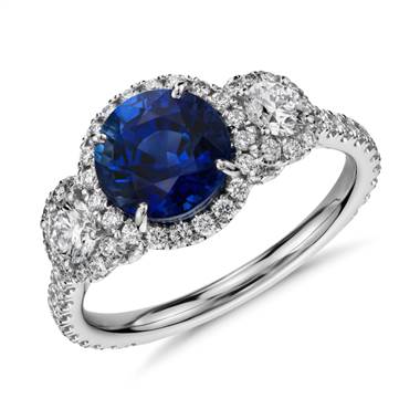 A Sapphire and Diamond Halo 3-Stone Ring set in 18K White Gold.