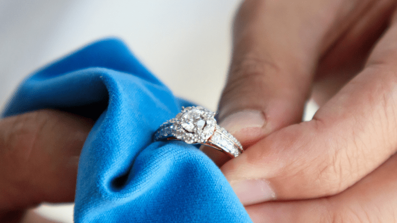 A man polishing a diamond ring.