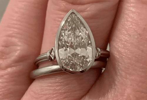 2.6+ carat pear shaped diamond ring. Its set in platinum with tri-wire and two French cut side stones.