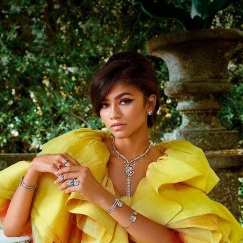Zendaya in bright yellow exaggerated dress, modeling Bvlgari jewelry, sharp cat eye eyeliner, nude lip, 