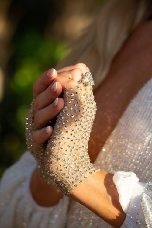 clasped hands, lace and crystal fingerless gloses and the engament ring profile. 