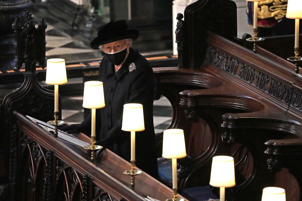 Queen Elizabeth II standing alone at her husband's socially distanced funeral