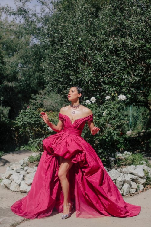 Jurnee Smollett ina low cut pink gown with a gorgeous necklace and silver shoes