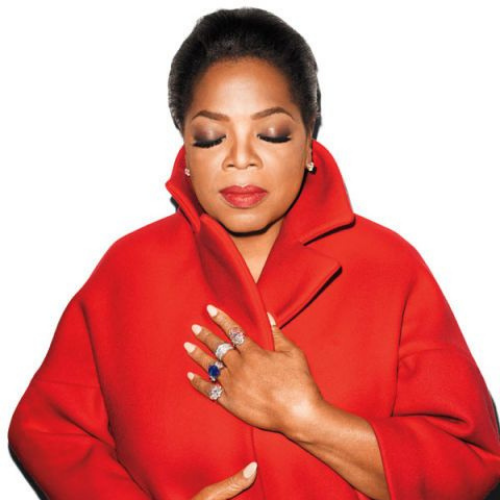 Oprah Winfrey headshot wearing a red coat and cocktail rings.