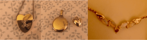 On a patterned background grey and white) with a gold heart with a K inscribed on it. A tiny gold charm, and a round gold locket. and a necklace centerpiece with rubies and opals