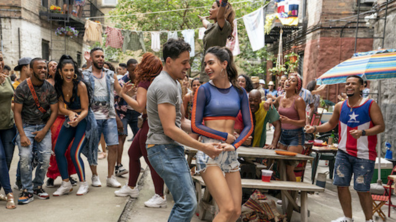 Many people dancing in the street with a couple focused in the center