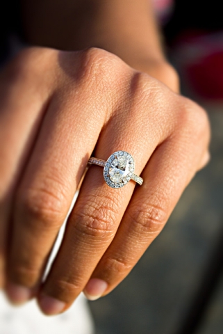 oval diamond ring in halo on beautiful long fingers