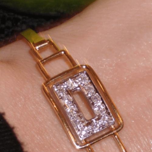 gold and diamond art deco bracelet on a wrist