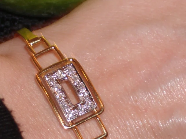 gold and diamond art deco bracelet on a wrist