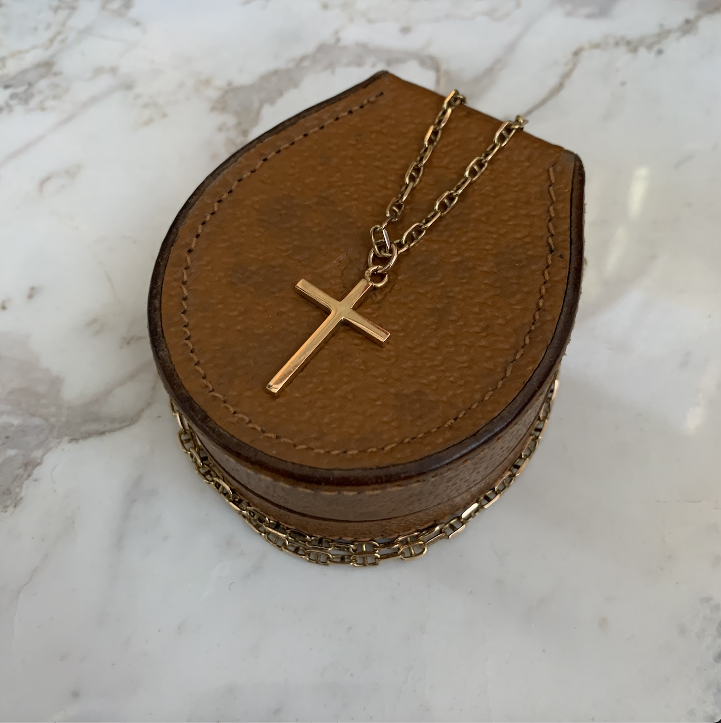 Gold cross necklace.