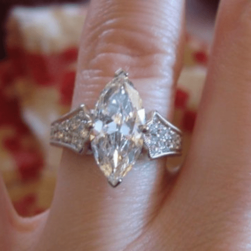 Chunky Marquise diamond engagement ring on a hand.
